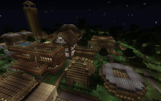 A large Minecraft town at night, lit by lanterns